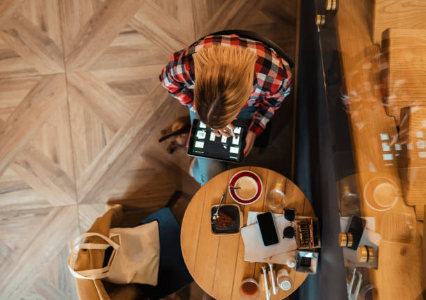 istock At modern cafeteria, female freelancer working remotely 1349767574