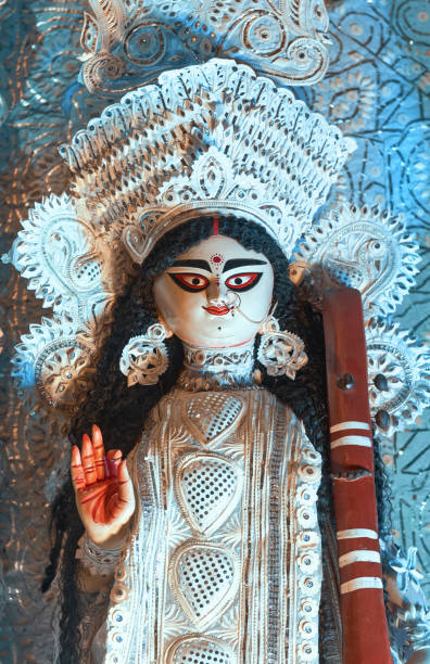Beautiful idol of Hindu Goddess Saraswati decorated in white pith, during Saraswati Puja, organised in the day of Vasant Panchami. She is Hindu goddess of knowledge, music, art, wisdom and learning.