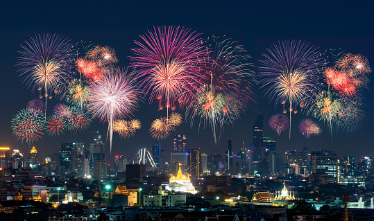 Firework with cityscape night light view of Thailand, Bangkok city skyline at twilight time, public scene from view point at the rooftop of tower.