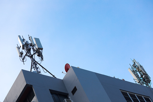 Two masts with wireless repeater towers for 4g and 5g on rooftop