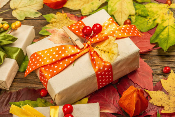 istock Zero waste gift concept with autumn design. Warm sweaters, fall leaves, thematic decor 1349772491