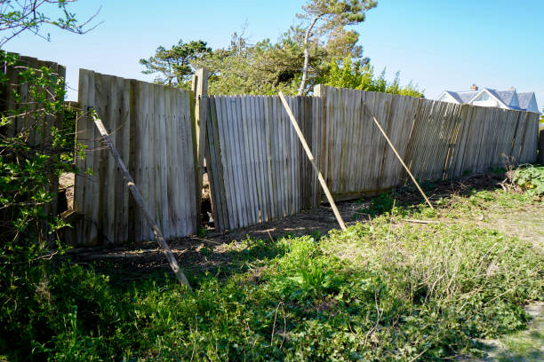 istock Falling down and damaged wooden fence 1349773354