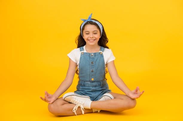 istock Life balance. Good vibes. Peaceful meditating. Learn meditating techniques. Stay positive and optimistic. Private space to relax. Yoga training. KId adorable girl sit meditate. Meditating practice 1349773958