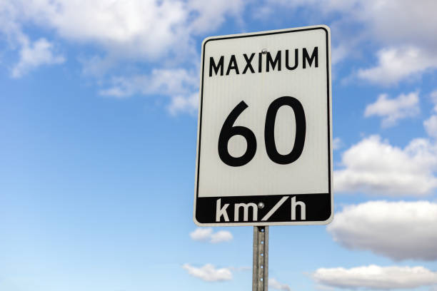 Speed limit road sign against blue sky with clouds, 60 km maximum driving in a street