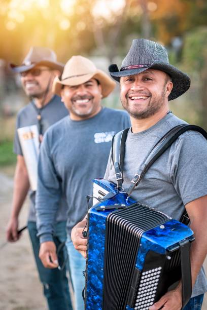 three hispanic mature agricultural male workers wearing cowboy hats looking at the camera - band 40s imagens e fotografias de stock