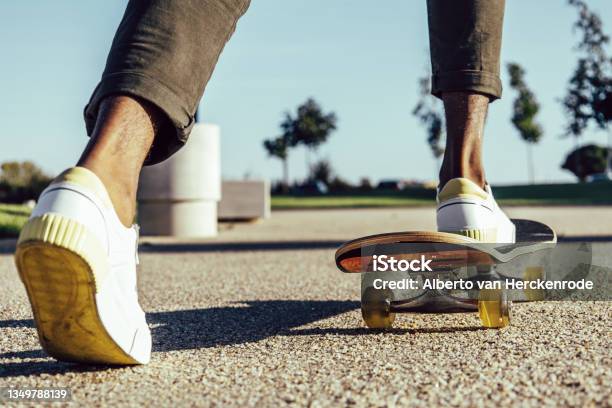 Closeup Of Black Legs Riding Skateboard In Park Stock Photo - Download Image Now - Skateboarding, Skateboard, Generation Z