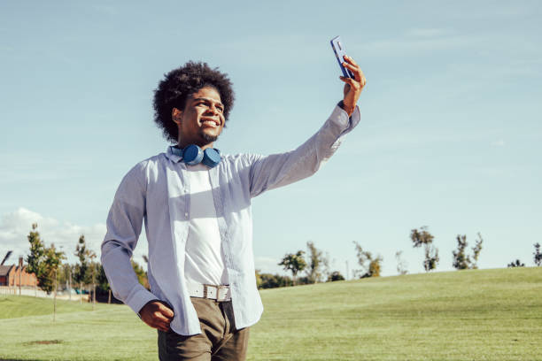 istock Young afro man taking selfie in a park 1349789814