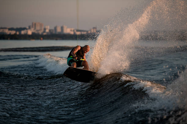 istock strong man trying to stand on splashing wave on a wakeboard 1349790307