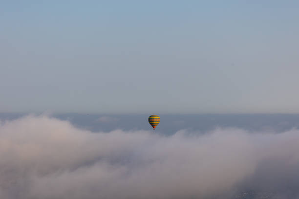 istock Hot air balloon on over the clouds before sunset time 1349792181