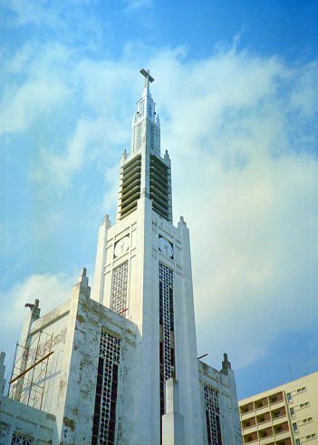 Maputo, Mozambique: Cathedral of Maputo, 1944 - designed by the civil engineer Marcial Simões de Freitas e Costa in Art Deco style. The main façade is staggered, with a four-level tower in the center that stands out from the rest, giving it a great sense of verticality and monumentality, the side crevices and large stained-glass windows on the front and front facades provide light and ventilation - Catedral de Lourenço Marques / Catedral de Maputo / Catedral de Nossa Senhora da Conceição.
