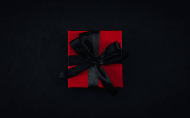 istock One red small gift box with a black ribbon tied in a bow 1349793197