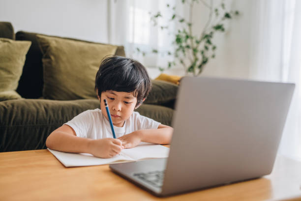istock Asian boy studying on a video call at home 1349793205