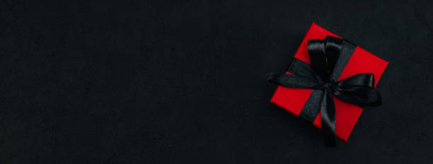 istock Red gift box with black satin ribbon 1349793430