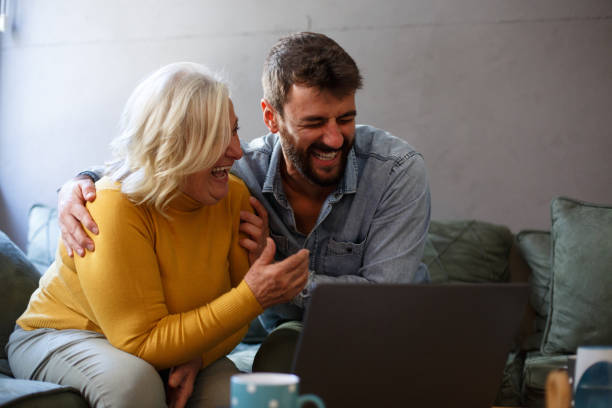 istock A young man is hugging his mother. They are talking and smiling, having a good time. 1349793703