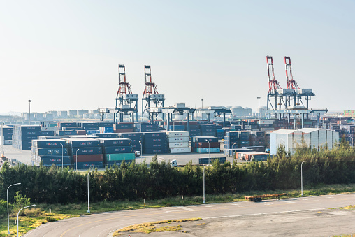 Taichung, Taiwan- October 4, 2021: Look over Containers and cranes along the coast of Taichung Port in Taiwan. It is the second-largest port in Taiwan after Kaohsiung Port.