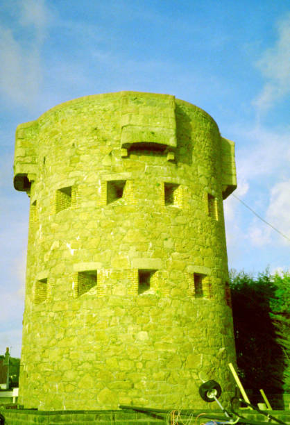 Saint Peter parish, Bailiwick of Jersey, Channel Islands: Beaumont Tower, a.k.a. St Aubin's Third Tower - a small stand alone fort built in granite - the westernmost of three Conway round coastal towers built in the 18th century to defend St Aubin's Bay on the English Channel from French incursions - St. Aubin's Bay Promenade.