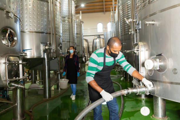 istock Male worker in mask working at winery 1349798134