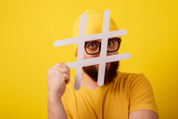 istock stylish bearded man in glasses looking into hashtag 1349802024