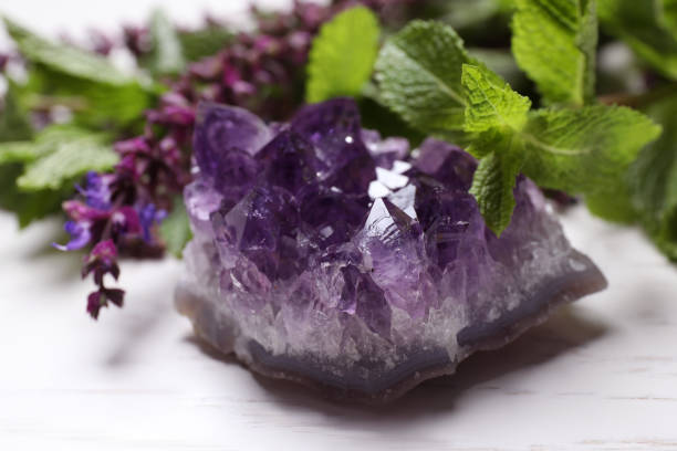 istock Amethyst gemstone and healing herbs on white wooden table, closeup 1349802567