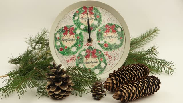 Round  decorative clock face showing the motion of the hands  towards midnight, time lapse. Christmas and New Year holidays