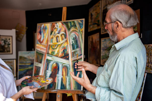 istock Teacher and student working in art school 1349806882