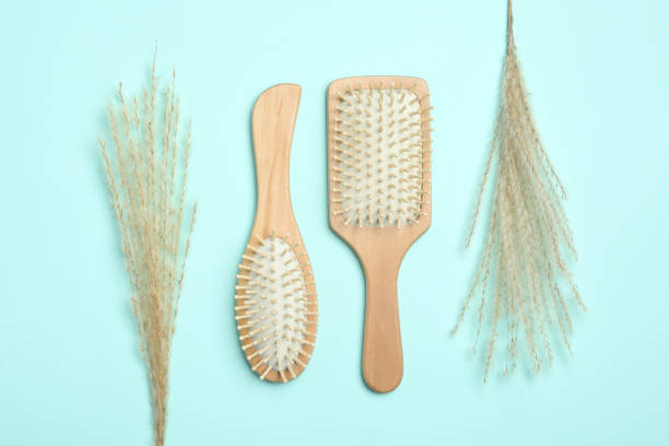 istock Modern hair brushes and spikelets on light blue background, flat lay 1349807906