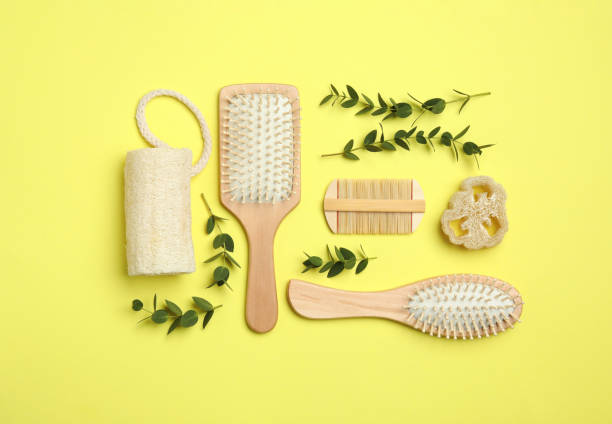 istock Flat lay composition with modern hair comb and brushes on yellow background 1349808003