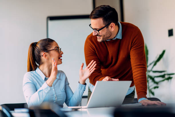 istock Young female employee consulting with manager 1349809317