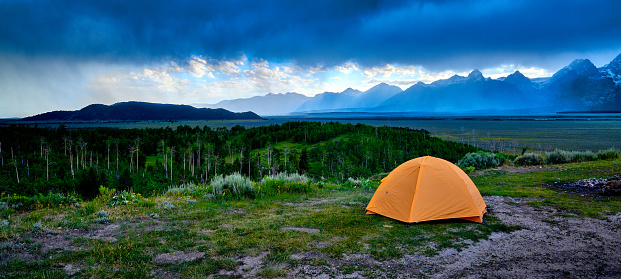 Tent on a ridge with approaching stom.