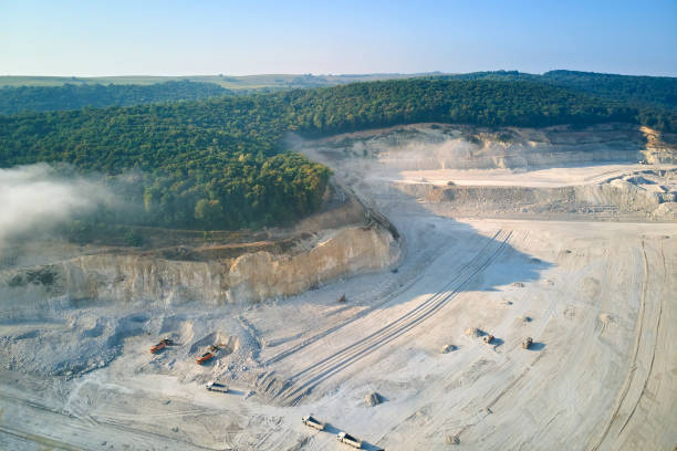 istock Aerial view of open pit mining site of limestone materials extraction for construction industry with excavators and dump trucks. 1349809590