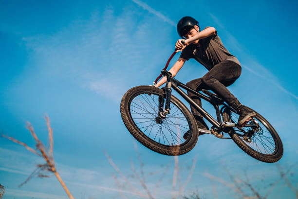 istock Mountain biker flying through the air after jumping off a ramp 1349813271
