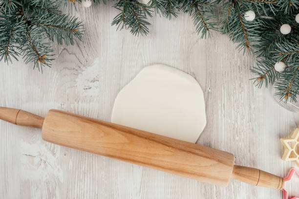 Step-by-step Christmas stars cold porcelain garland tutorial. Step 9: Roll with rolling pin to desired thickness stock photo