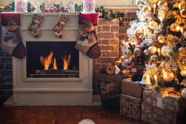 istock Decorated Christmas Tree Near Fireplace at Home 1349814429