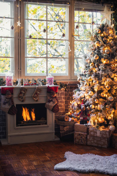 istock Decorated Christmas Tree Near Fireplace at Home 1349814454