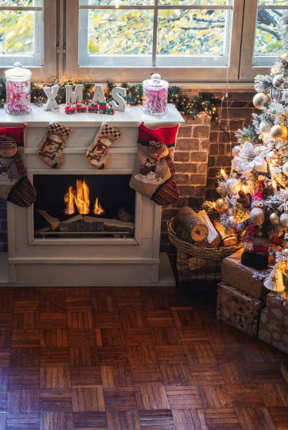 istock Decorated Christmas Tree Near Fireplace at Home 1349814472