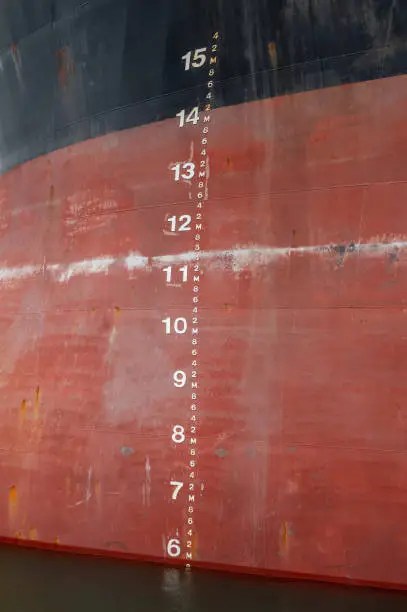 Photo of Waterline and draft scale measure orange black ship