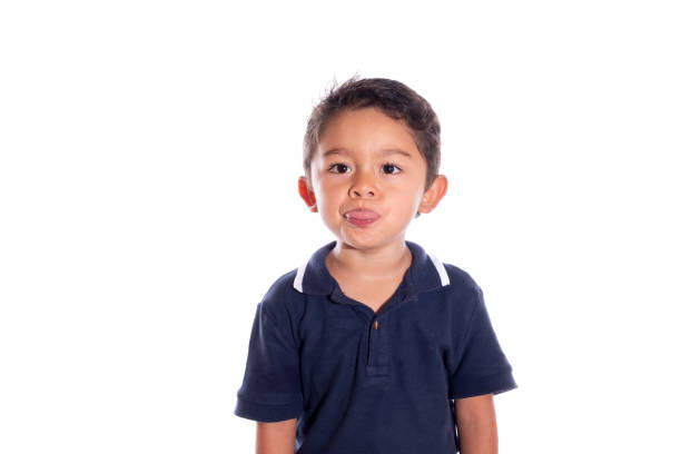 istock Child gesturing to camera, isolated on white background. Latin boy making faces with mouth. 1349817312