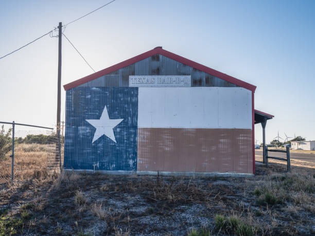 Adrian, Texas USA - October 25,2021: Texas BBQ building displays a Texas State Flag painted on one of the exterior corrugated metal walls along Route 66.