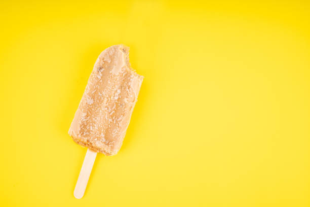 istock Tea flavored ice cream sticks on yellow background. Copy space for your text 1349817642