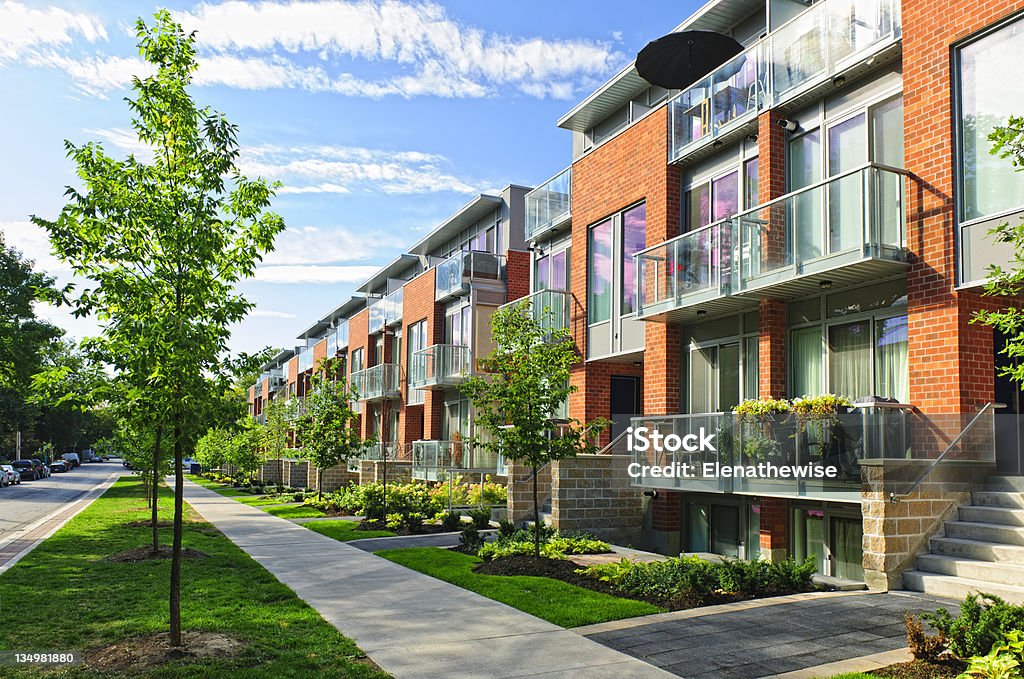 Modern town houses Modern town houses of brick and glass on urban street Townhouse Stock Photo
