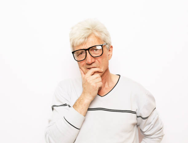 istock old age, problem and people concept: Portrait of Thoughtful old man with eyeglasses 1349820218