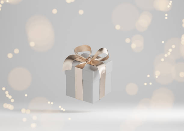 istock White gift box with golden ribbon bow levitating on gray background. Flying christmas present with bokeh lights. Commercial for woman concept. Creative realistic minimal banner 3d render 1349821546