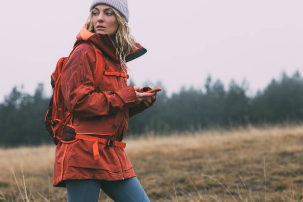 istock Beautiful Female Hiker Exploring the Mountains, Using her Smartphone to Navigate 1349823048