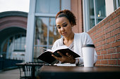 istock Woman Studying At Outdoor Urban Cafe 1349828698