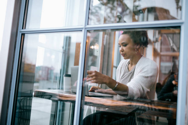 istock Woman Working On Laptop At Cafe 1349828717