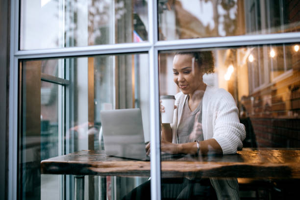istock Woman Working On Laptop At Cafe 1349828789