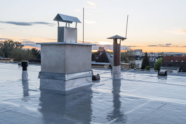 istock Flat roof covered with bitumen membrane and silver lacquer with chimney on a private house. Reflections on roof after rain 1349830659