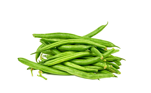 fresh green beans on white bowl, aka french beans, string beans or snaps, harvested vegetable on a rustic table top, taken straight from above with copy space