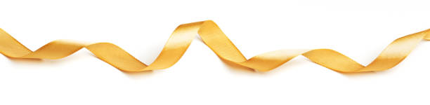 istock Wavy golden ribbon isolated on white background. 1349849509