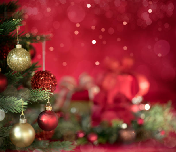Christmas Tree and Gifts on a Red Bokeh Background